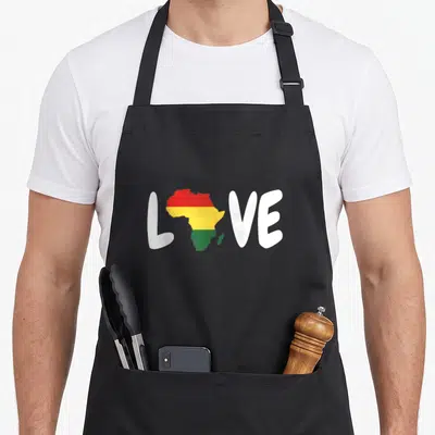 Africa african print apron - Map of Africa filled with red yellow and green stripes replacing the O in white LOVE text — shown on a black cotton canvas apron against a white background
