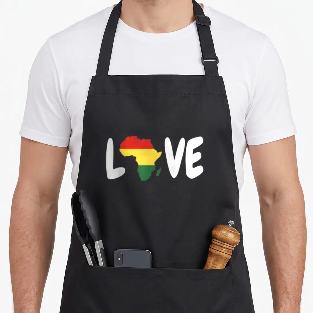 Africa african print apron - Map of Africa filled with red yellow and green stripes replacing the O in white LOVE text — shown on a black cotton canvas apron against a white background