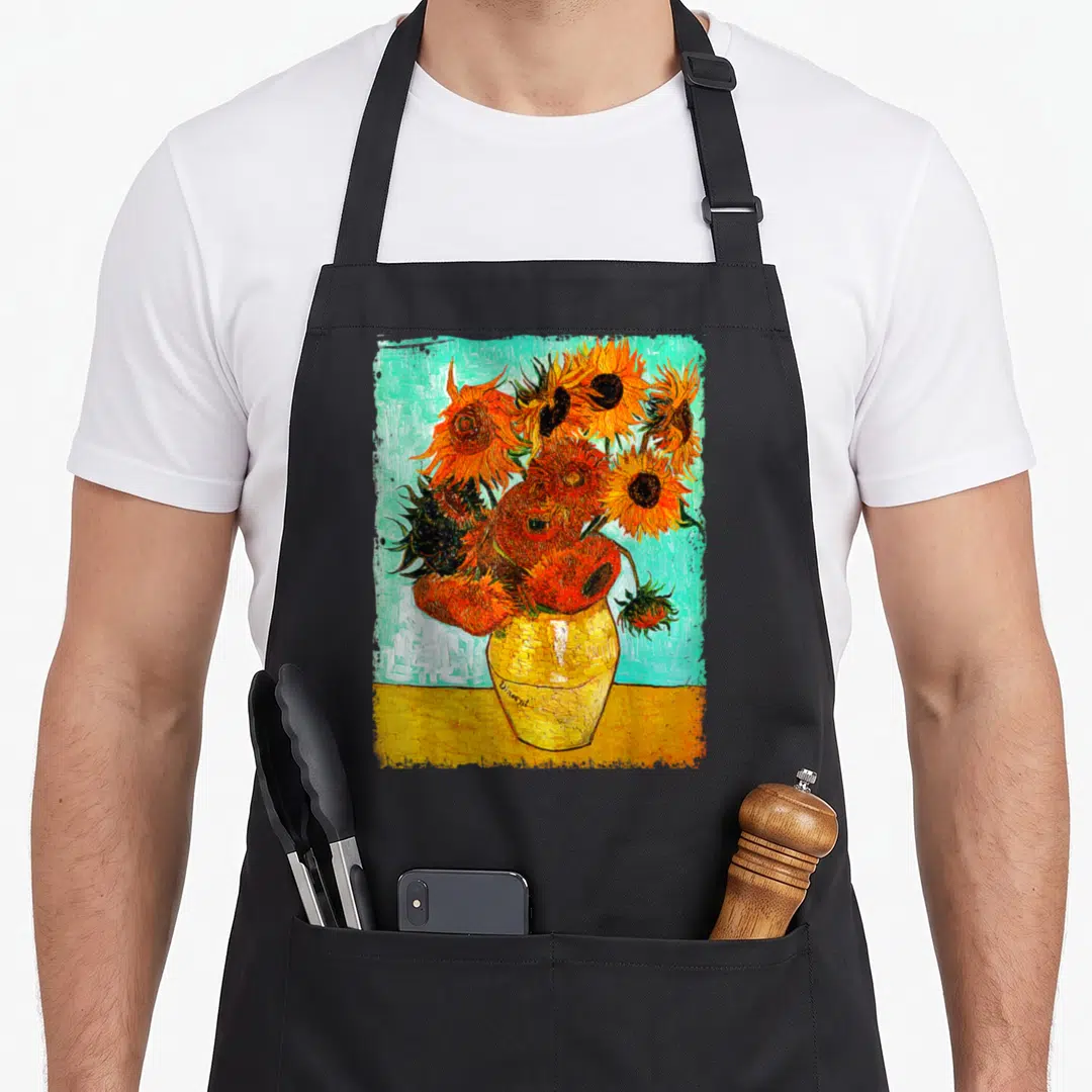 Gif van gogh apron - Sunflower bouquet in yellow vase with Vincent signature on teal background — shown on a black cotton canvas apron against a white background