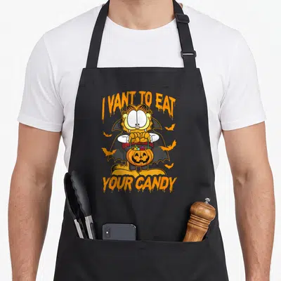 Eat candy halloween apron - Garfield vampire holding pumpkin bucket with I Vant To Eat Your Candy text — shown on a black cotton canvas apron against a white background