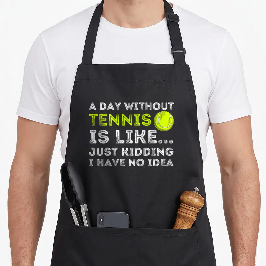 Tennis headband apron - A Day Without Tennis quote with lime green ball and white text on black — shown on a black cotton canvas apron against a white background