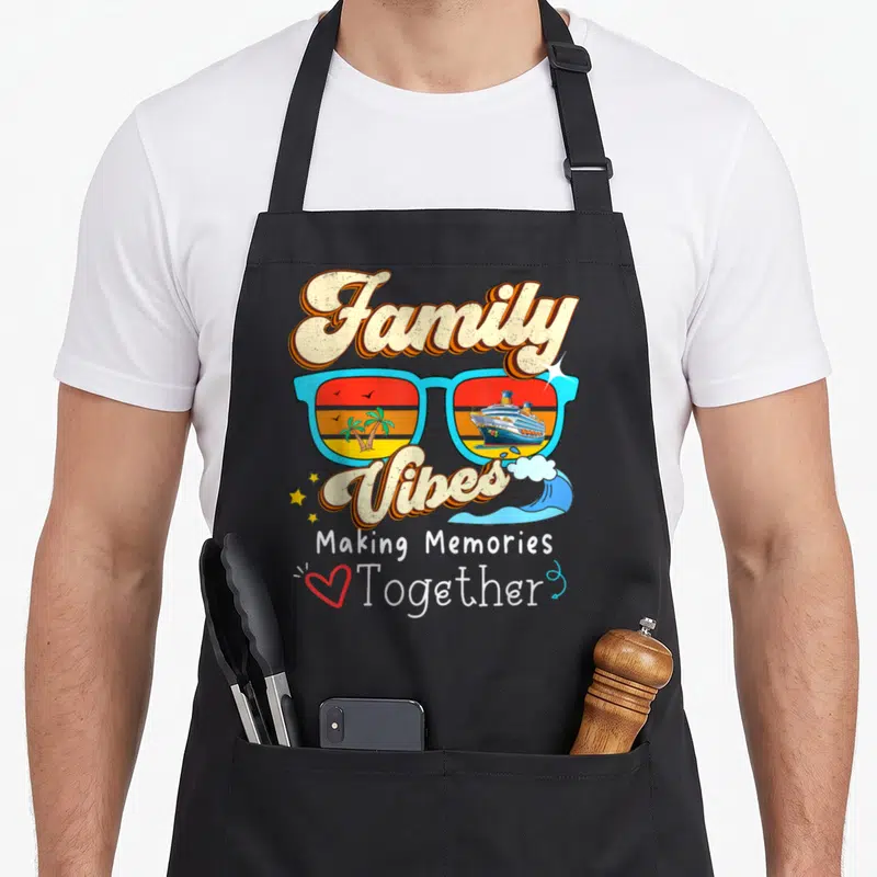 Making together memory apron - Retro sunglasses with ship and palm tree scenes surrounded by Family Vibes text — shown on a black cotton canvas apron against a white background