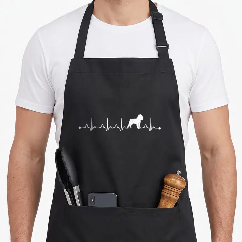 Eternity dog apron - White EKG heartbeat line containing a standing Brussels Griffon dog silhouette — shown on a black cotton canvas apron against a white background