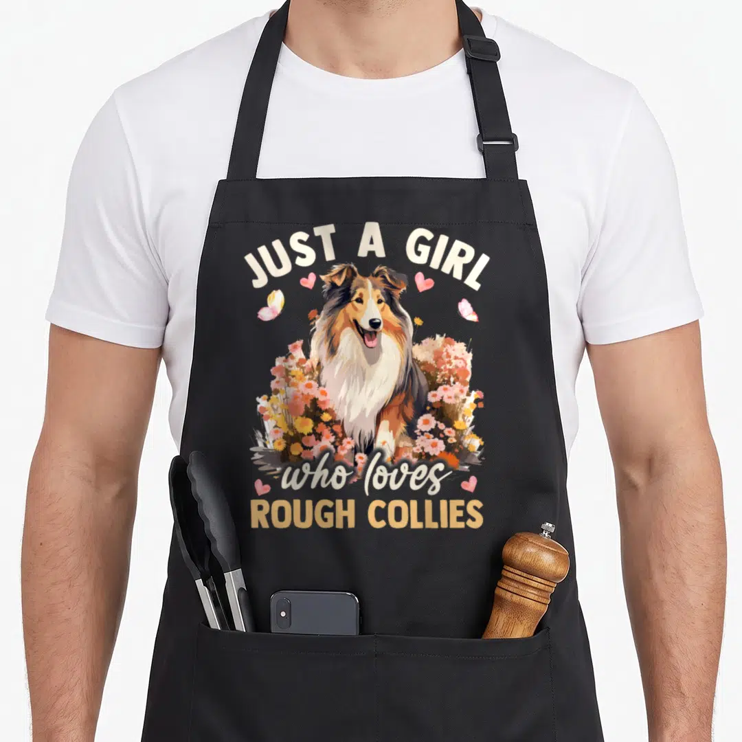 Rough floral apron - Realistic Rough Collie surrounded by pink yellow flowers with hearts butterflies and arched text — shown on a black cotton canvas apron against a white background