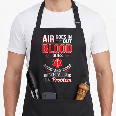 Emt nurse apron - Air goes in out blood goes round and round text with red EMT Star of Life and heartbeat line — shown on a black cotton canvas apron against a white background