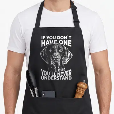 Funny shorthaired pointer apron - Distressed white dog head with arched text IF YOU DON'T HAVE ONE on grey background — shown on a black cotton canvas apron against a white background