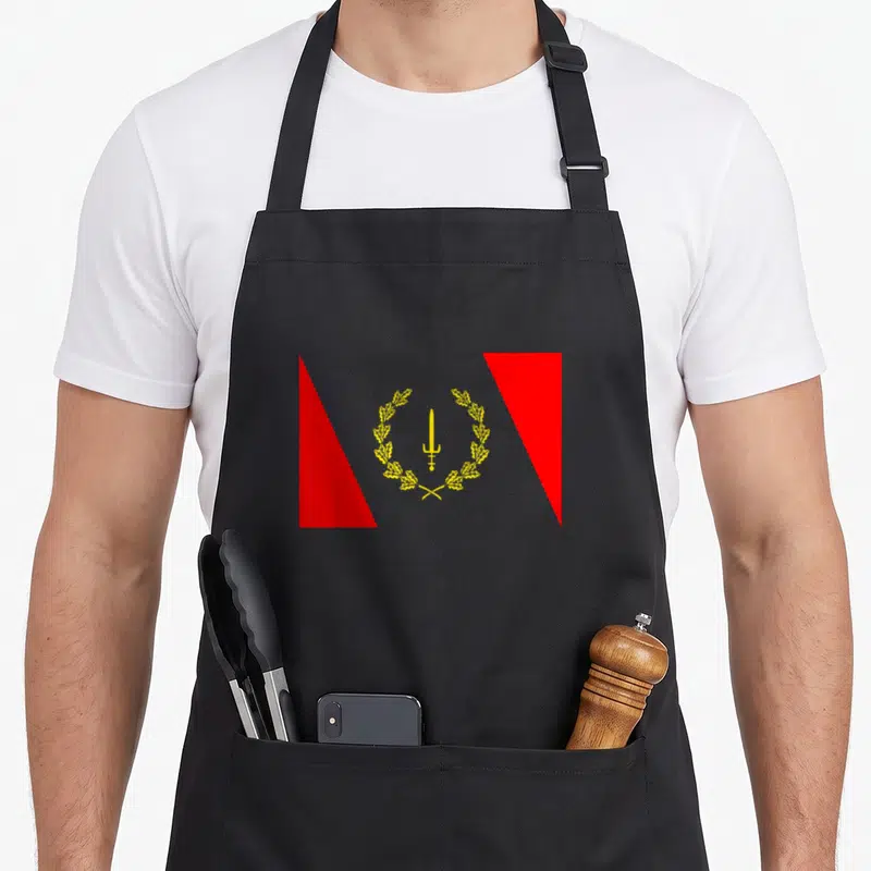 Heritage african american aprons - Yellow sword and wreath centered between two red triangles on grey background — shown on a black cotton canvas apron against a white background