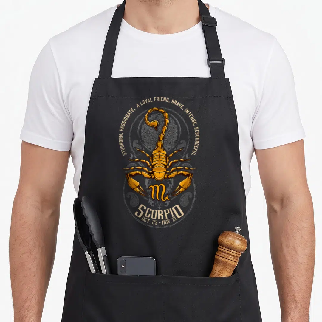 Scorpio birthday apron - Golden scorpion over grey mandala with text stubborn passionate loyal friend brave intense — shown on a black cotton canvas apron against a white background