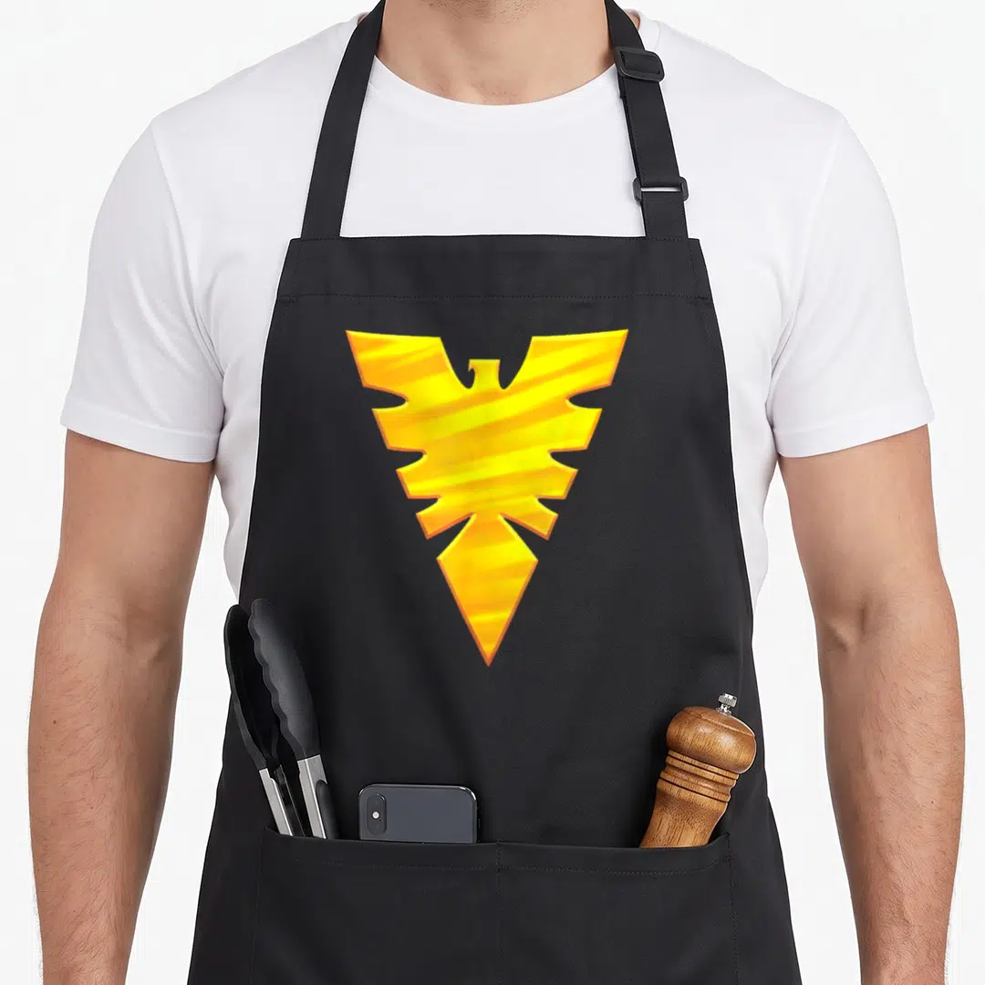 Firebird x apron - Stylized yellow and orange phoenix symbol centered on grey background — shown on a black cotton canvas apron against a white background