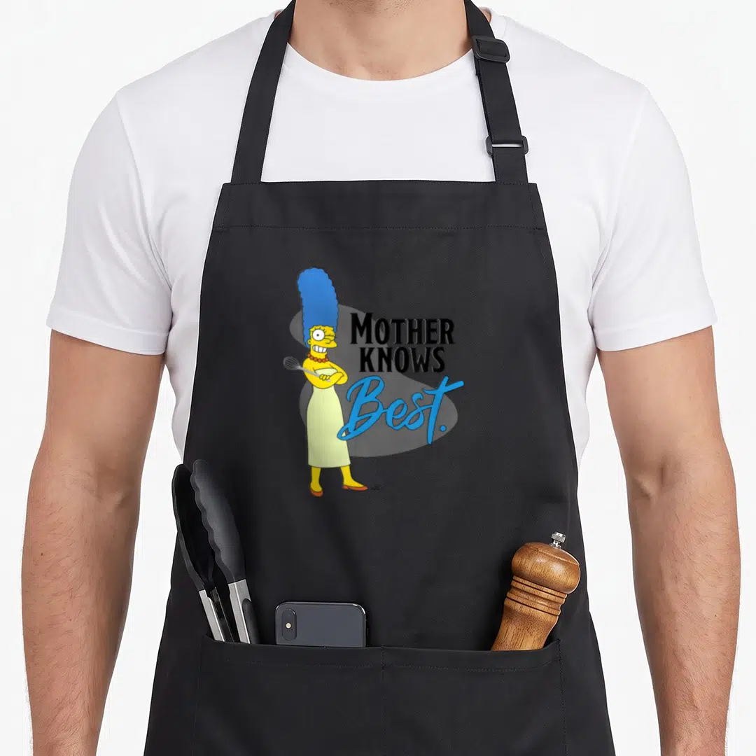 Marge mother's apron - Marge Simpson holding whisk next to stacked Mother Knows Best text in black and blue script — shown on a black cotton canvas apron against a white background