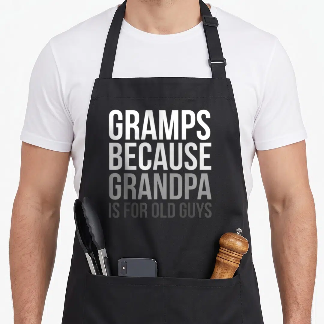 Vintage gramp grandpa apron - Stacked white and grey text reading Gramps Because Grandpa Is For Old Guys — shown on a black cotton canvas apron against a white background