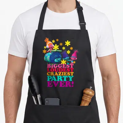 Troll character aprons - Three Trolls and yellow flowers above stacked colorful text reading biggest loudest craziest — shown on a black cotton canvas apron against a white background