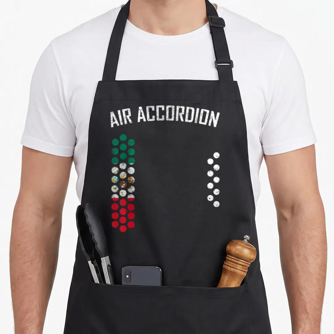 Air mexico apron - Arched text above green red and white dots forming accordion shape — shown on a black cotton canvas apron against a white background