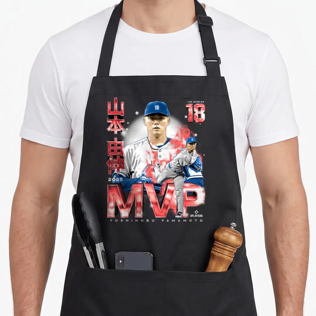Yoshinobu baseball fan apron - Yoshinobu Yamamoto portrait with MVP text, red smoke, and Japanese characters on black — shown on a black cotton canvas apron against a white background
