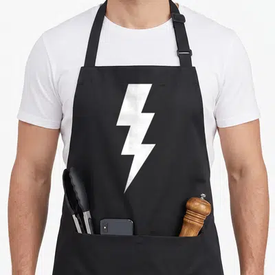 Power electricity apron - Single white lightning bolt centered on grey background, minimalist geometric shape — shown on a black cotton canvas apron against a white background
