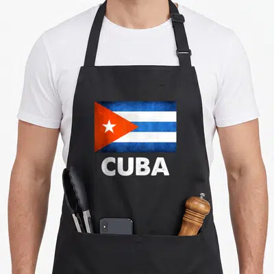 Cuba cuban boy apron - Distressed flag of Cuba with blue white red stripes and star above white CUBA text — shown on a black cotton canvas apron against a white background
