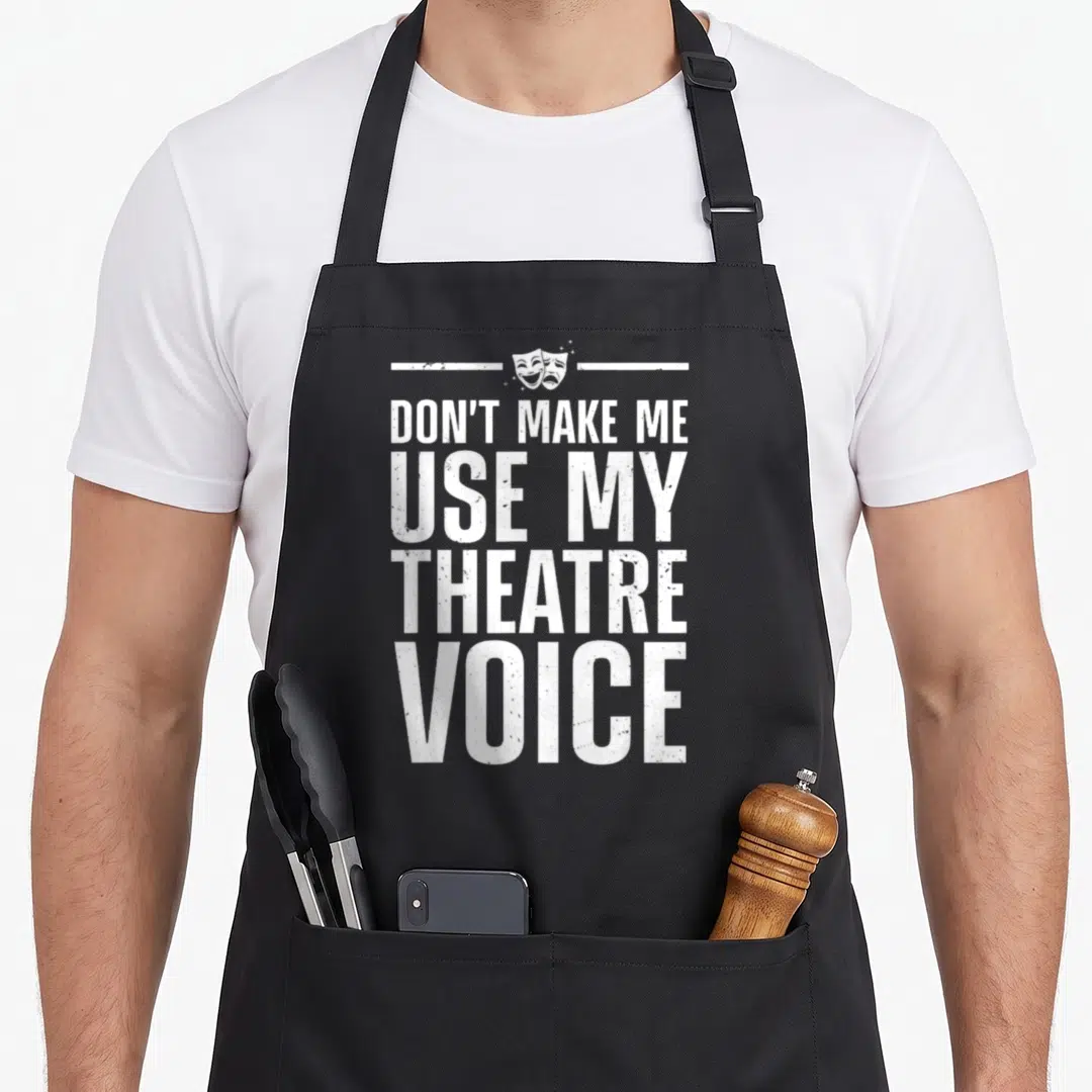 Theater theatre apron - White distressed text and two theater masks centered between horizontal lines — shown on a black cotton canvas apron against a white background