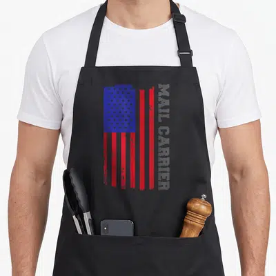 Carrier patriotic apron - Distressed US flag in red white blue with vertical grey MAIL CARRIER text — shown on a black cotton canvas apron against a white background