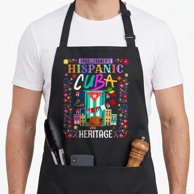 Heritage chef outfit with apron - Colorful Cuban flag, coffee cup, buildings, and text reading Orgullosamente Hispanic — shown on a black cotton canvas apron against a white background