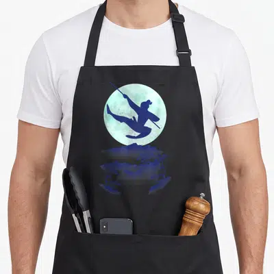 Jump sky apron - Martial artist silhouette jumping with staff against moon and blue mountains in watercolor style — shown on a black cotton canvas apron against a white background