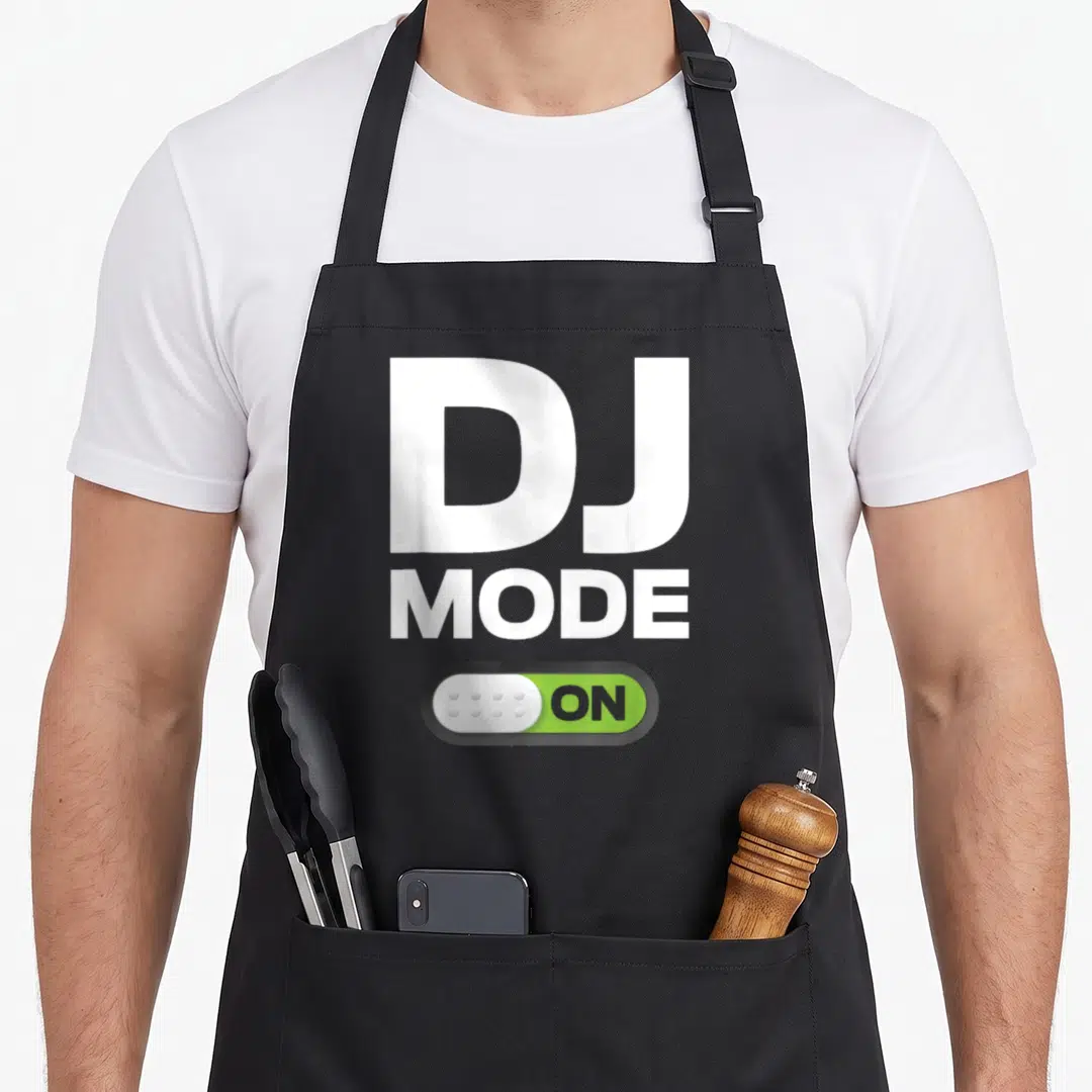 Mode djing life apron - Toggle switch graphic reading DJ MODE ON in white and green — shown on a black cotton canvas apron against a white background