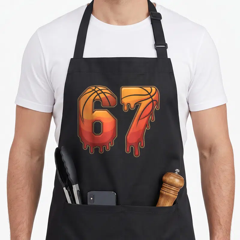 Basketball gen meme apron - Cartoon 67 numbers with basketball texture and orange red yellow dripping liquid design — shown on a black cotton canvas apron against a white background