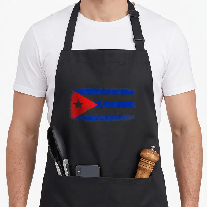 Cuba travel pride apron - Distressed Cuban flag with blue white red stripes and star — shown on a black cotton canvas apron against a white background