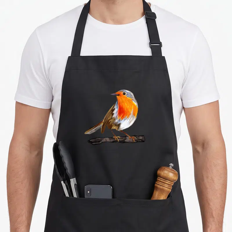 Funny robin bird apron - Realistic bird perched on branch in orange grey and brown plumage — shown on a black cotton canvas apron against a white background
