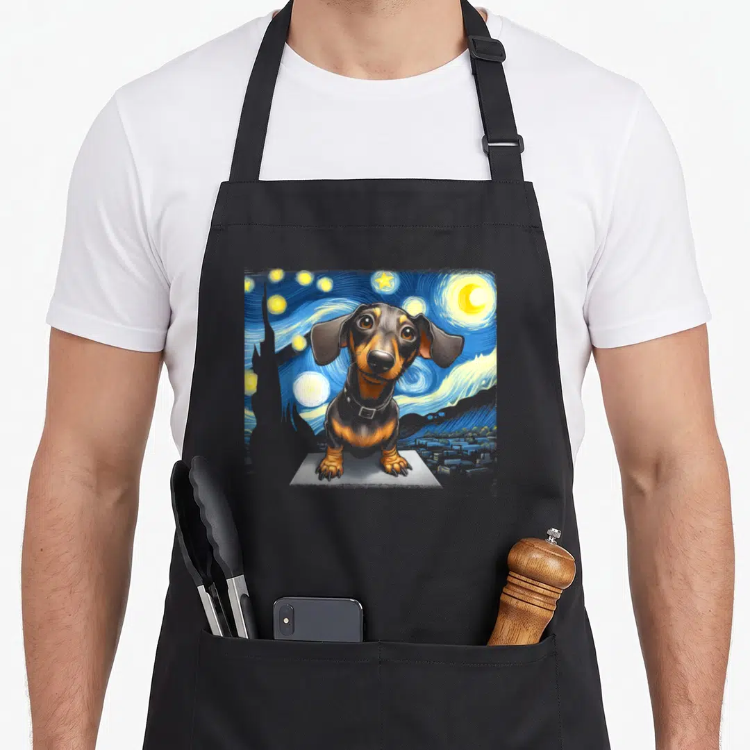 Dog sausage apron - Dachshund sitting on pedestal against swirling blue starry night sky in watercolor style — shown on a black cotton canvas apron against a white background