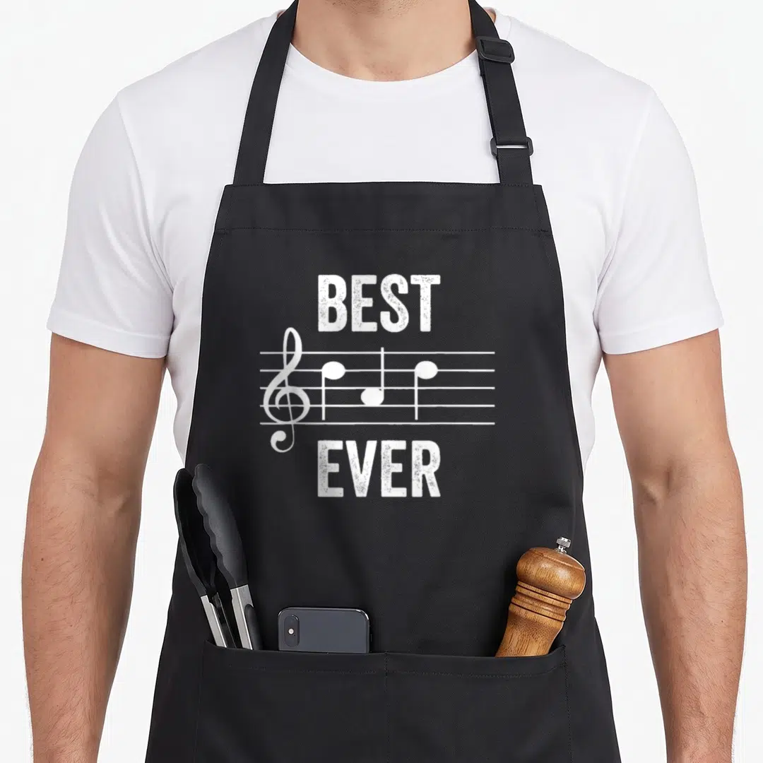 Music note father day apron - White distressed musical staff with treble clef, three notes, and BEST EVER text — shown on a black cotton canvas apron against a white background