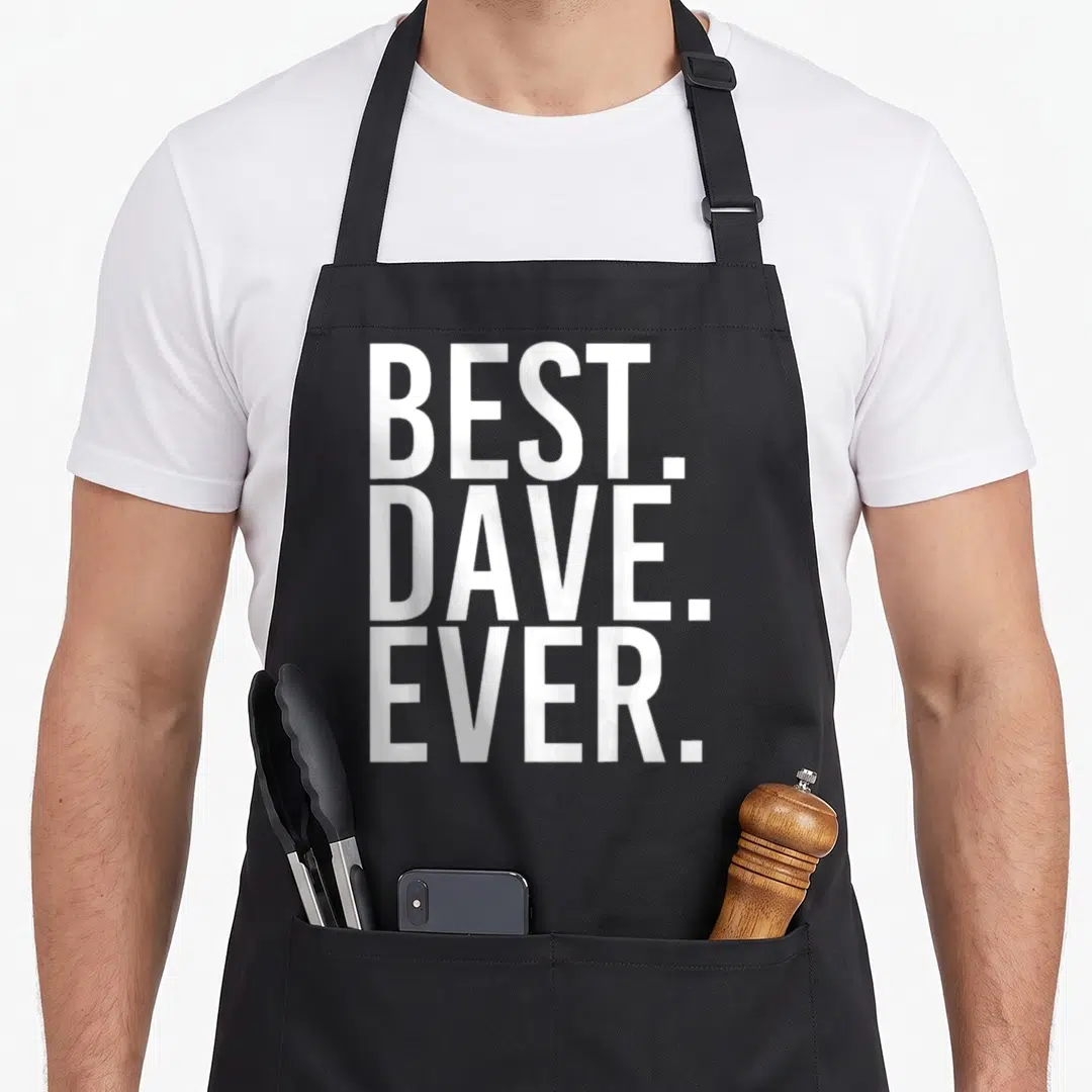 Dave father apron - Stacked white text BEST. DAVE. EVER. on grey background — shown on a black cotton canvas apron against a white background