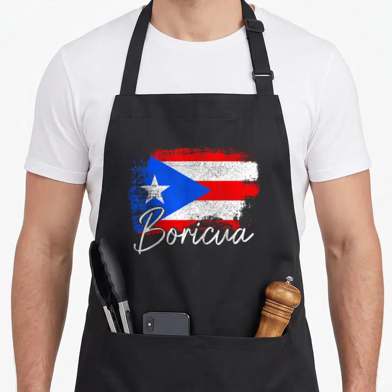 Rico pride apron - Distressed Puerto Rican flag with white Boricua script overlay in red, white, and blue — shown on a black cotton canvas apron against a white background