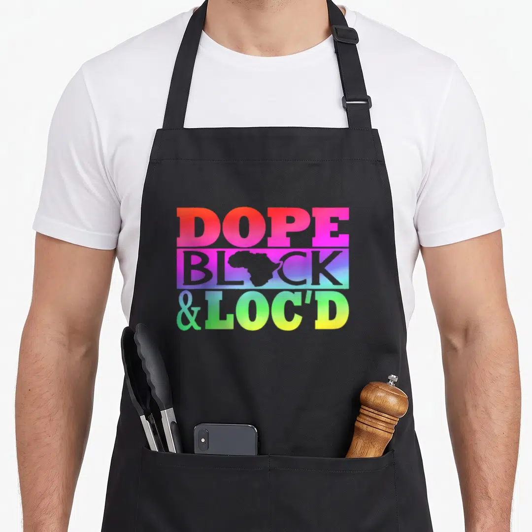 Dope black apron - Stacked DOPE BLOCK &LOC'D text with Africa map silhouette in rainbow gradient — shown on a black cotton canvas apron against a white background