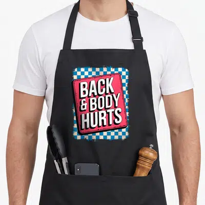 Bodybuilder body apron - Tilted red sign reading BACK & BODY HURTS over blue and white checkerboard — shown on a black cotton canvas apron against a white background