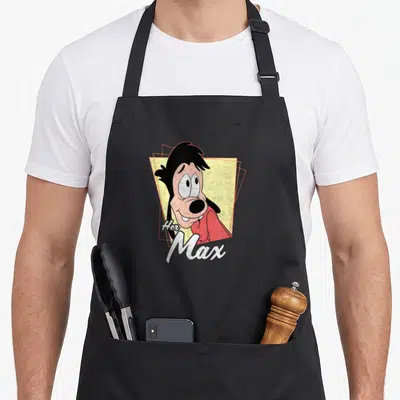 Max distressed apron - Cartoon Goofy face with Her Max text on yellow geometric background — shown on a black cotton canvas apron against a white background