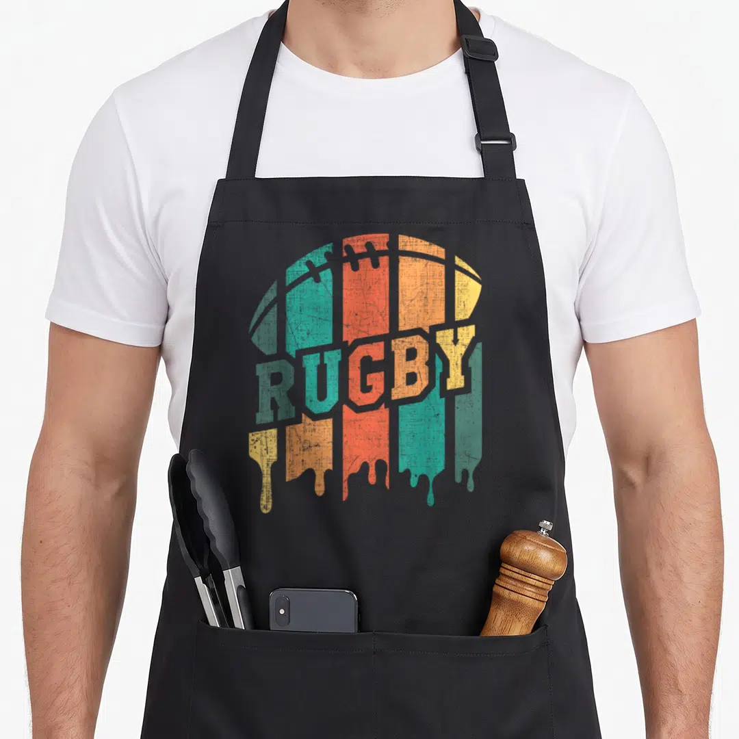 Player rugby apron - Retro rugby ball with dripping teal orange and yellow paint and centered text — shown on a black cotton canvas apron against a white background