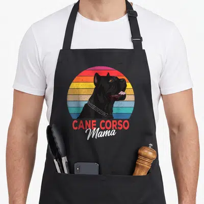 Mama italian apron - Retro Cane Corso dog head on multi-colored striped circle with stacked red and white text — shown on a black cotton canvas apron against a white background