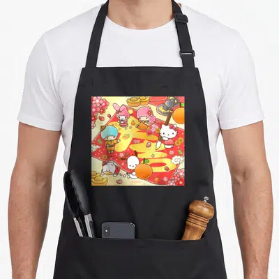 Calligraphy friends apron - Sanrio characters on red sheet with yellow calligraphy, oranges, flowers, and gold ingots — shown on a black cotton canvas apron against a white background