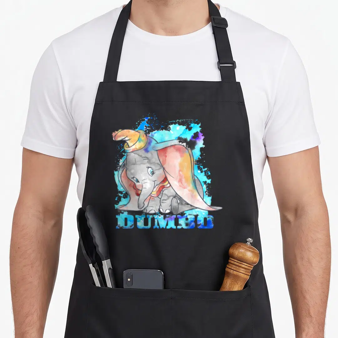 Dumbo classical lover apron - Watercolor elephant character wearing a hat with blue grey pink and yellow splashes — shown on a black cotton canvas apron against a white background