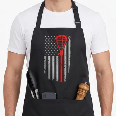 Youth american flag apron - Red lacrosse stick silhouette over distressed white stars and stripes pattern — shown on a black cotton canvas apron against a white background