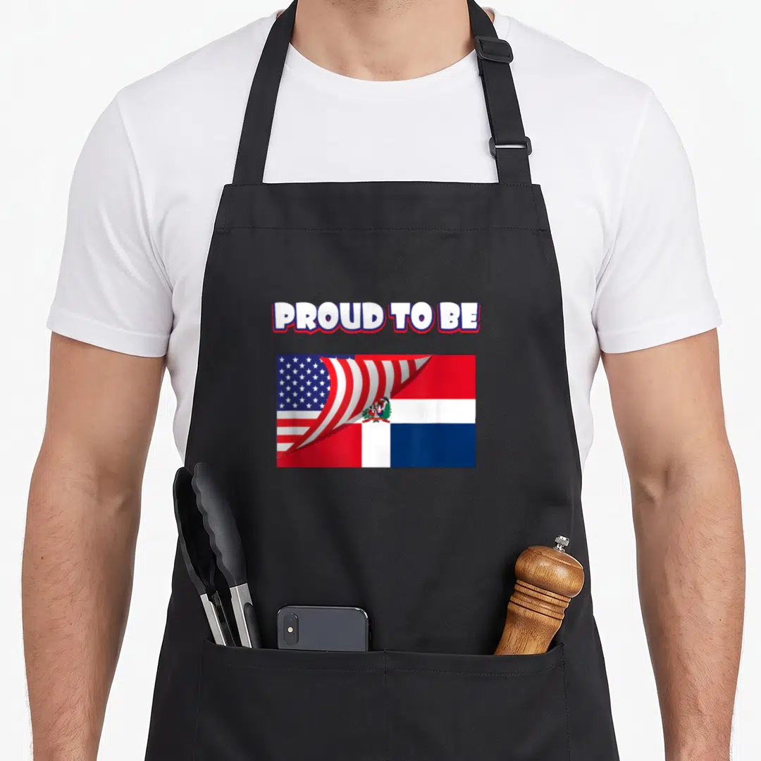 Dominican 4th of july apron - PROUD TO BE text above merged US and Dominican Republic flags in red white blue — shown on a black cotton canvas apron against a white background