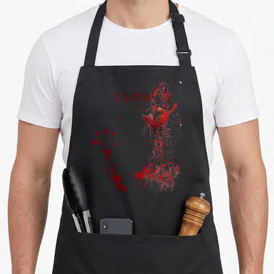 Halloween fine bloody apron - I'm fine text beside a red bloody handprint with splatters — shown on a black cotton canvas apron against a white background