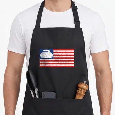 Flag curling stone apron - Distressed red white and blue flag with white curling stone silhouette in blue corner — shown on a black cotton canvas apron against a white background