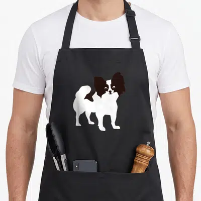 Funny papillon apron - Minimalist white and brown Papillon dog illustration on apron front — shown on a black cotton canvas apron against a white background
