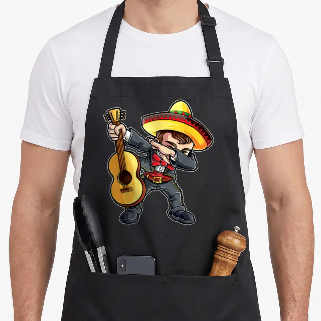 Mariachi mexican apron - Cartoon mariachi musician dabbing while holding a guitar in yellow, red, and grey — shown on a black cotton canvas apron against a white background