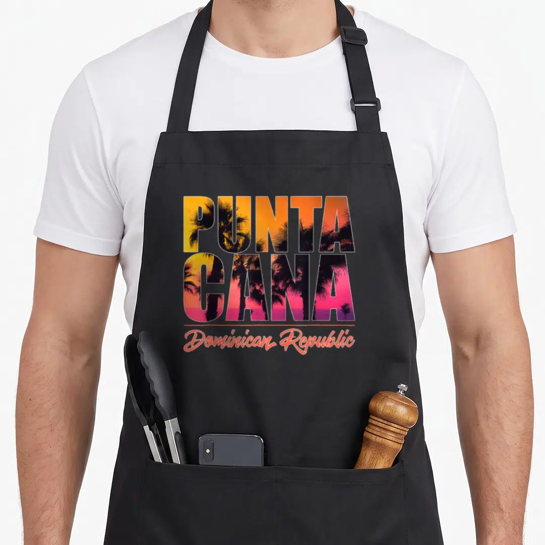 Punta have better apron - PUNTA CANA stacked block letters with sunset palm trees and Dominican Republic script — shown on a black cotton canvas apron against a white background