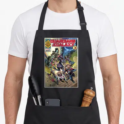 Guardian cosmo apron - Guardians of the Galaxy Vol 3 characters leaping forward in comic book style — shown on a black cotton canvas apron against a white background