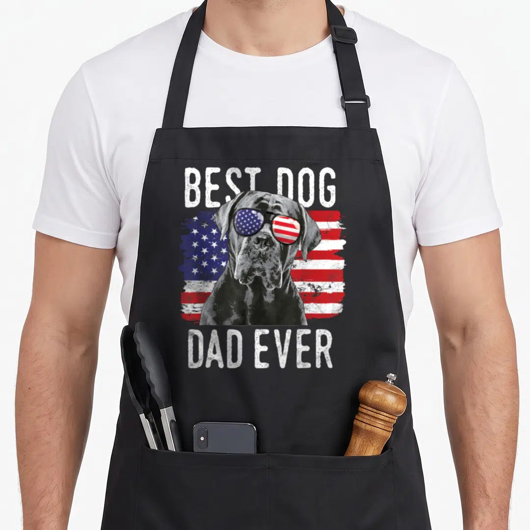 Flag cane apron - Dog in sunglasses over distressed flag with Best Dog Dad Ever text — shown on a black cotton canvas apron against a white background