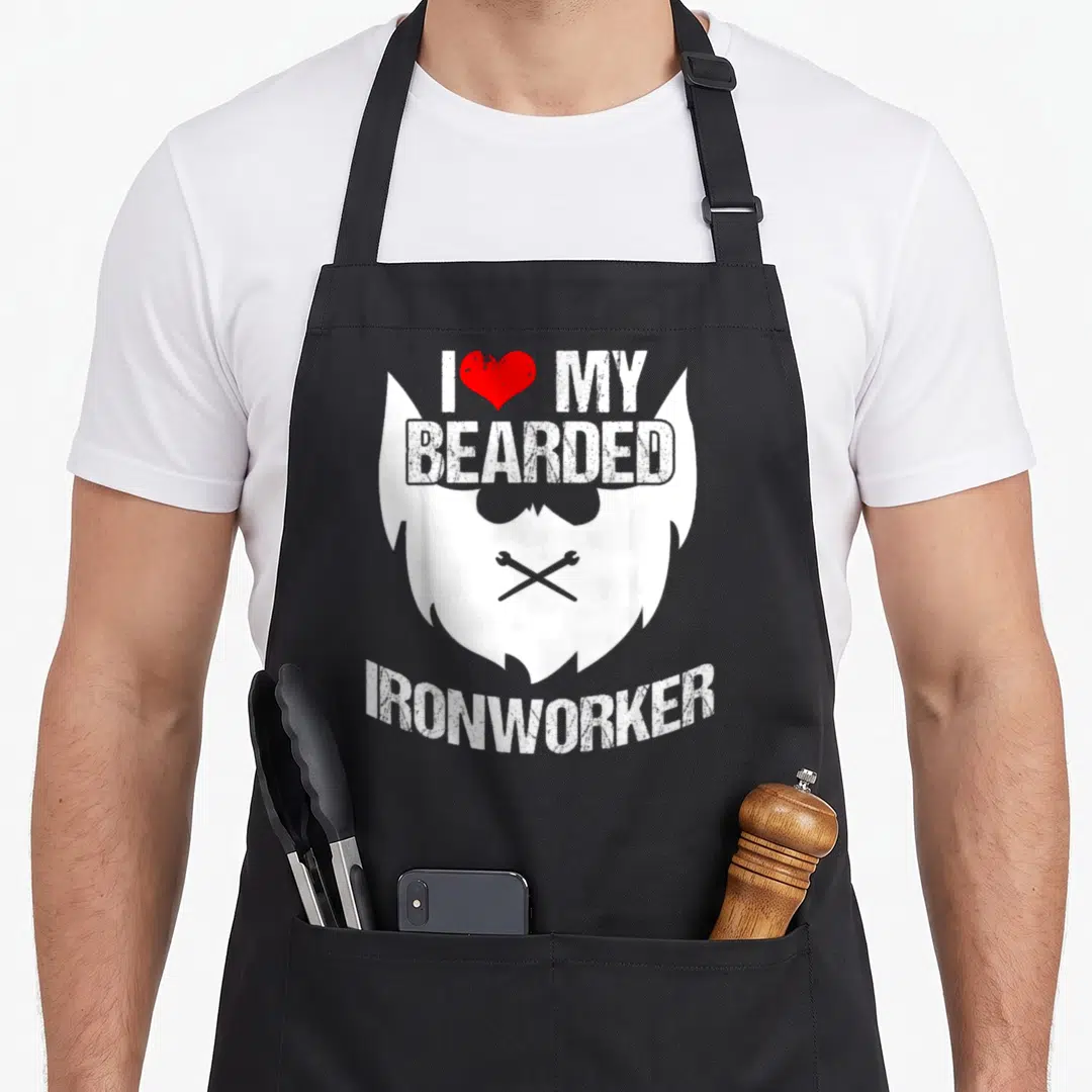 Ironworker metal worker apron - White beard silhouette with crossed wrenches and distressed text I love my bearded — shown on a black cotton canvas apron against a white background