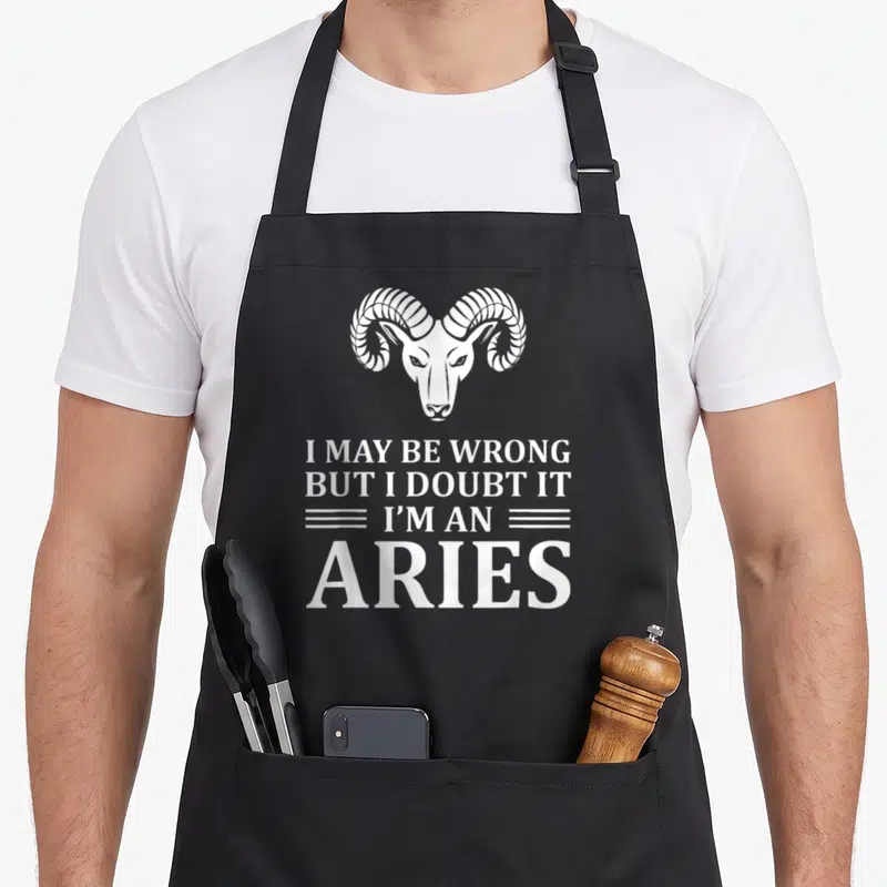 Wrong aries kitchen apron - White ram head above sarcastic Aries zodiac quote text — shown on a black cotton canvas apron against a white background